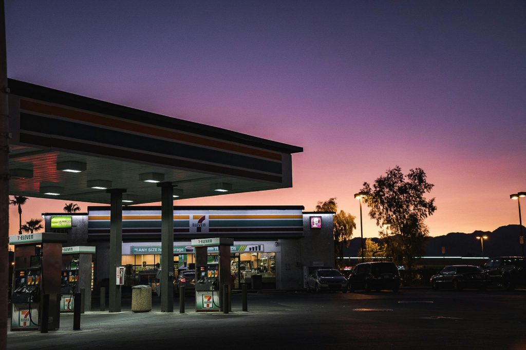 pexels photo 3116970 3116970 A gas station at dusk with a vibrant sunset background in an urban area.